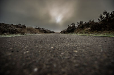 Surface level of road against sky at night
