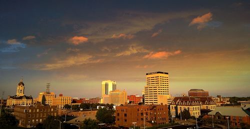 View of cityscape against cloudy sky