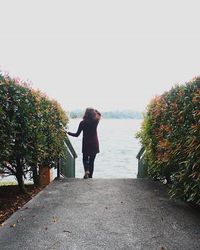 Full length of woman standing on tree trunk