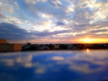 Scenic view of buildings against sky during sunset