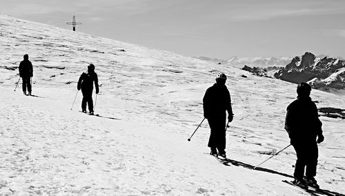 Tourists on snow covered mountain