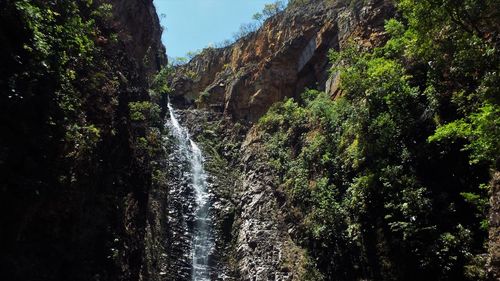 Low angle view of waterfall against sky