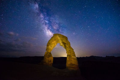 Rock formation against sky at night