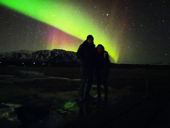 Silhouette of people standing on landscape