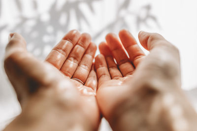 Hands of woman catching sunlight 