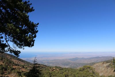 Scenic view of mountains against clear blue sky