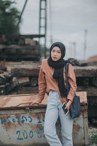 Portrait of young woman sitting outdoors