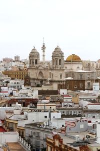 View of buildings in city against clear sky