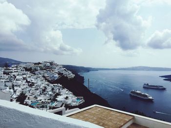 High angle view of townscape by sea against sky