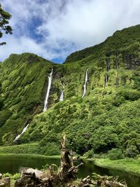 Scenic view of waterfall against sky