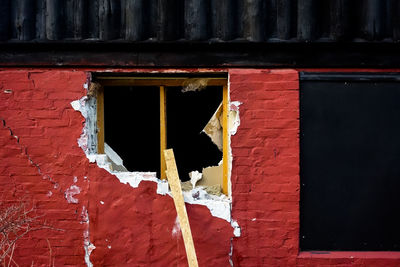 Exterior of red abandoned house