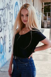 Portrait of young woman with hair standing outdoors