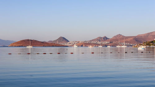 Scenic view of sea against clear blue sky