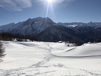 Scenic view of snow covered mountains against sky