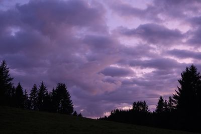 Silhouette of trees against dramatic sky during sunset