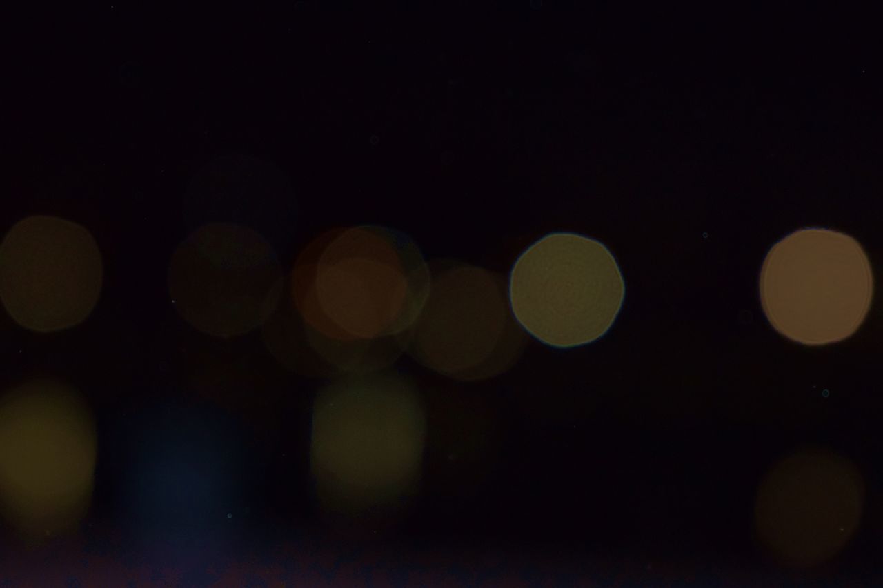 DEFOCUSED IMAGE OF ILLUMINATED LIGHTS