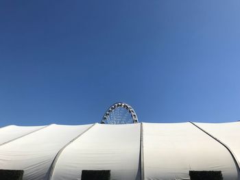 Low angle view of modern building against blue sky