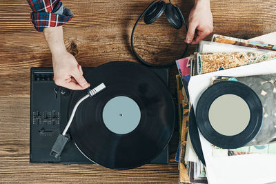 Listening to music from vinyl record. playing music from analog disk on turntable player. vintage