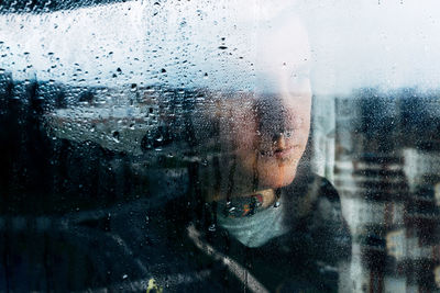 Close-up portrait of wet glass window in rainy season