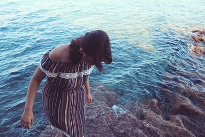 Woman in front of sea