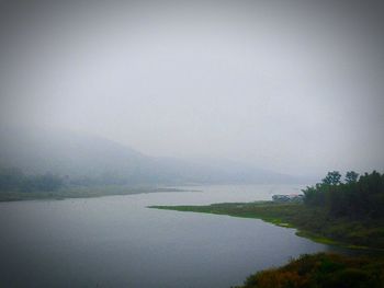 Scenic view of lake and mountains against clear sky