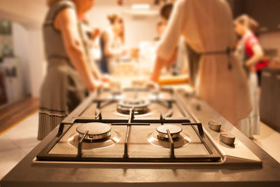 People standing on table in kitchen