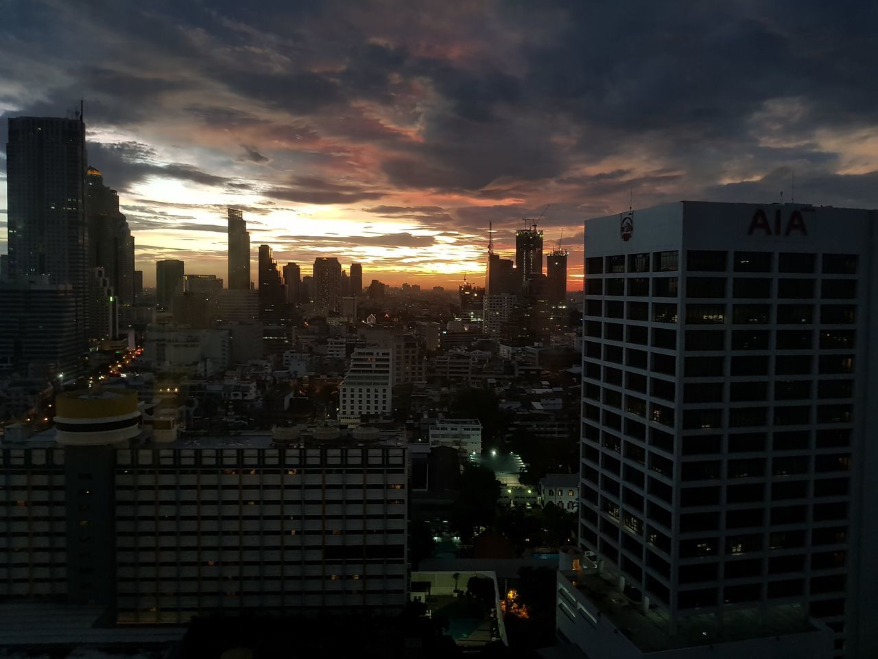 MODERN BUILDINGS IN CITY AGAINST SKY AT DUSK