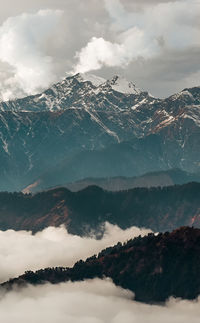 Scenic view of snowcapped mountains against sky