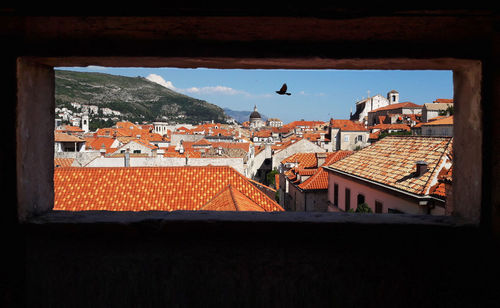 Houses in town against sky