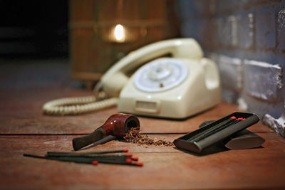 Close-up of old telephone on table