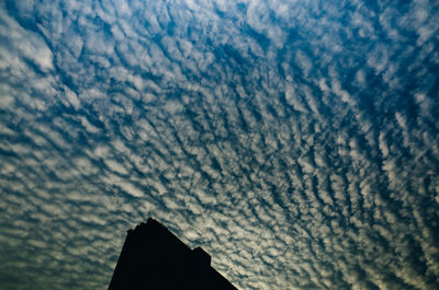 Low angle view of building against cloudy sky