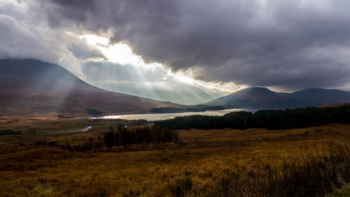 Scenic view of mountains against cloudy sky