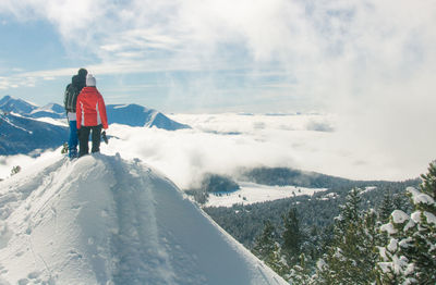 Rear view of man on snowcapped mountain