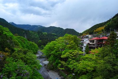 Scenic view of mountains and buildings against sky