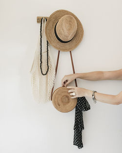 Still life of hanging accessories and woman hands