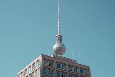 Low angle view of television tower against blue sky