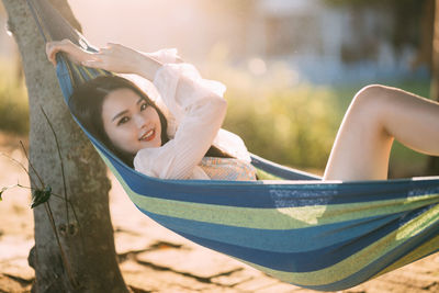 Portrait of young woman sitting on hammock