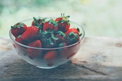 Close-up of strawberries in glass bowl on table