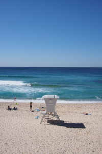 Scenic view of beach against blue sky