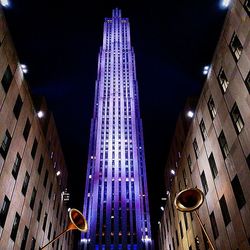 Low angle view of modern building against sky at night