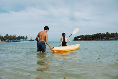 Man surfing in sea against sky