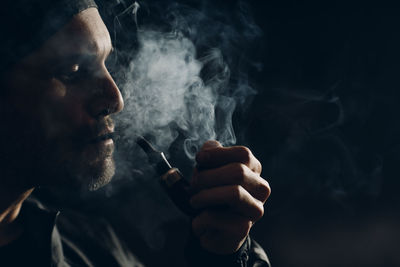 Portrait of man smoking cigarette