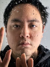 Close-up portrait of woman with water drops