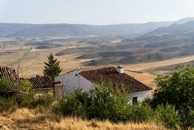 Houses on field against mountain