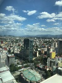 High angle view of buildings in city against sky