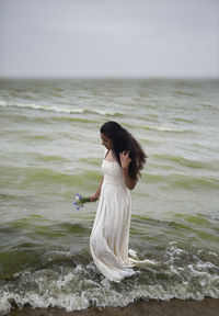 Side view of young woman on beach