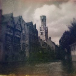 Buildings against cloudy sky