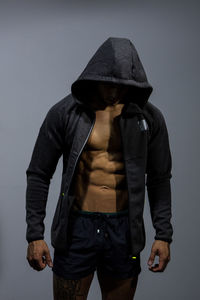 Close-up of muscular man in hood - clothing