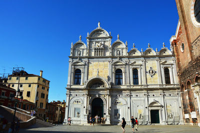 View of buildings against blue sky