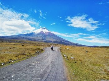 Road amidst landscape leading towards mountain